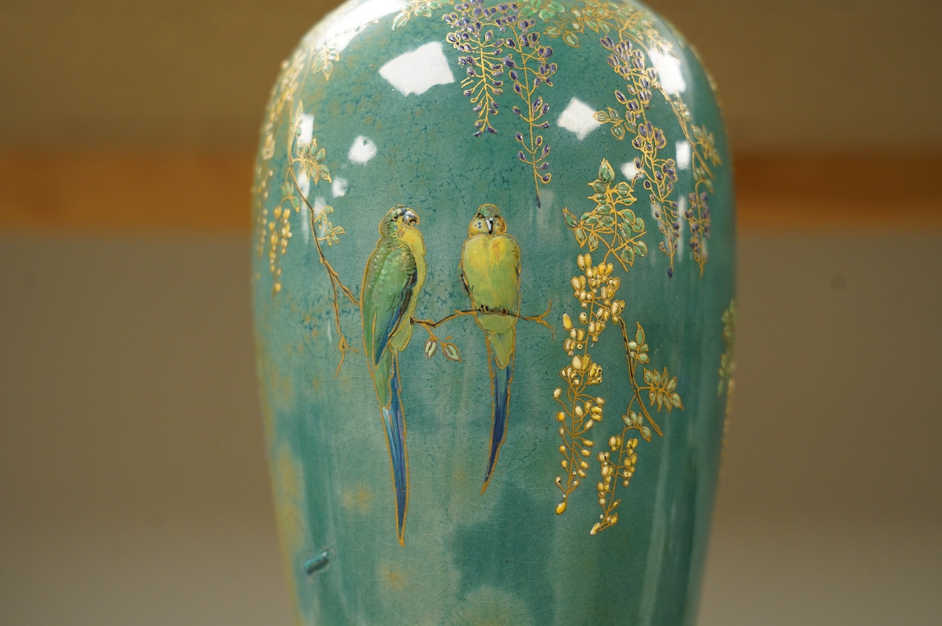 A Doulton Titanian ‘parakeet’ vase with raised floral and leaf design, 37cm high. Condition - considerable stapled restoration